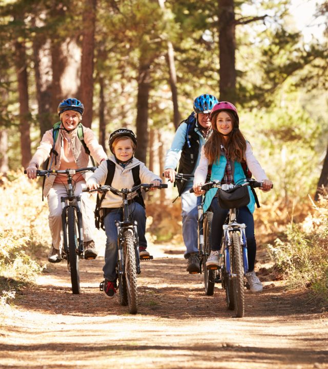 Grandparents,And,Kids,Cycling,On,Forest,Trail,,California Grandparents,And,Kids,Cycling,On,Forest,Trail,,California